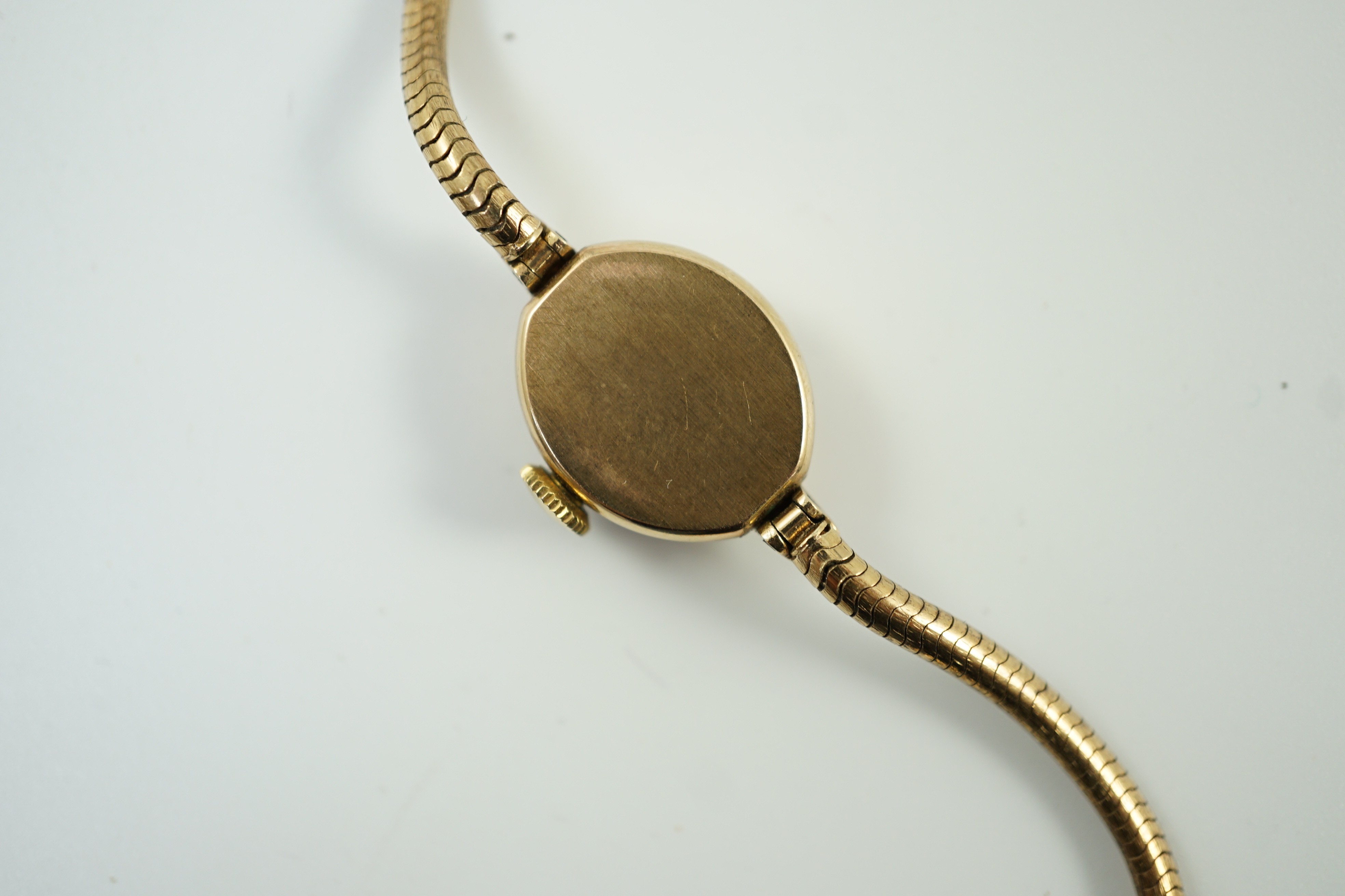 A lady's modern 9ct gold Rone manual wind wrist watch, on a 9ct gold snake link bracelet, overall 16.cm, gross 11.3 grams.